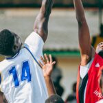 semifinais do NBB — Intense basketball game with players going for a jump shot, showcasing athletic skill and sportsmanship.