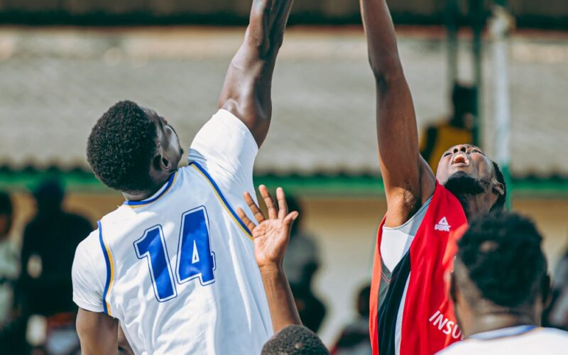semifinais do NBB — Intense basketball game with players going for a jump shot, showcasing athletic skill and sportsmanship.