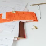 organizar documentos pessoais — Close-up of a tidy desk with receipts, documents, and office stationery for business organization.