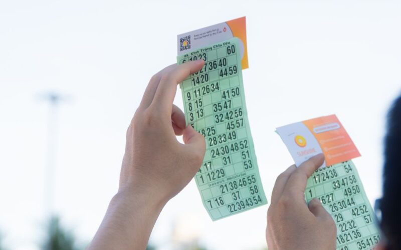 planejar uso do prêmio Mega-Sena — Close-up of hands holding transportation tickets, showcasing numbers and fare details.